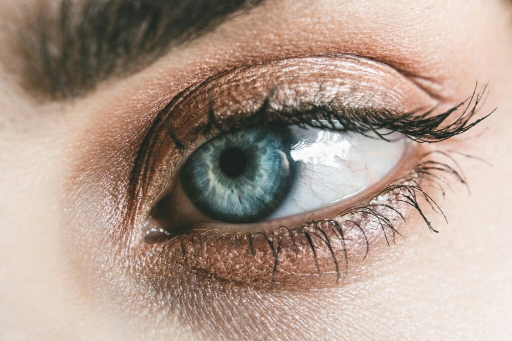 A picture of a woman's eye showing she uses caffeine in eye cream