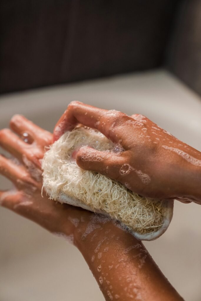 A woman bathing with a sponge