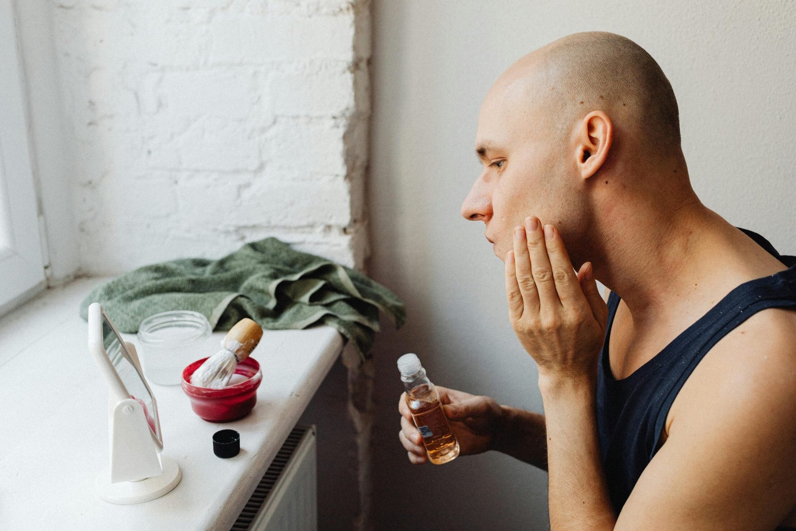 A man applying a face toner