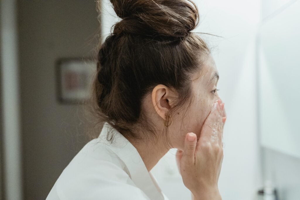 A woman using comparing oil or water cleanser