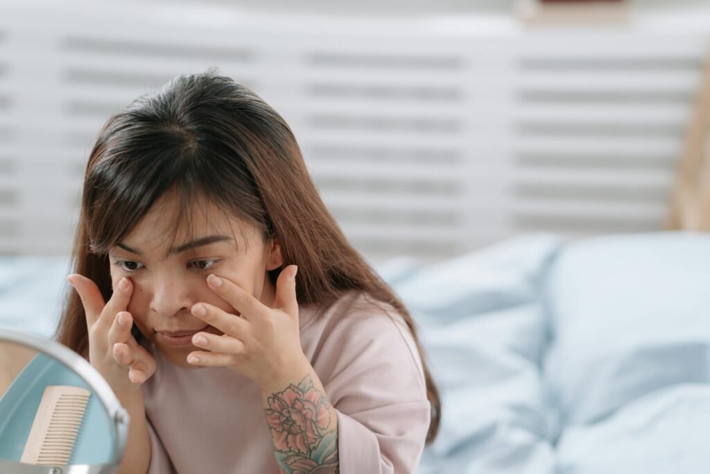 A woman applying eye cream