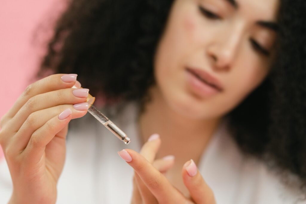 A woman putting a peptide serum on her finger