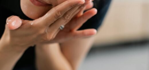 A woman rinsing her face with water