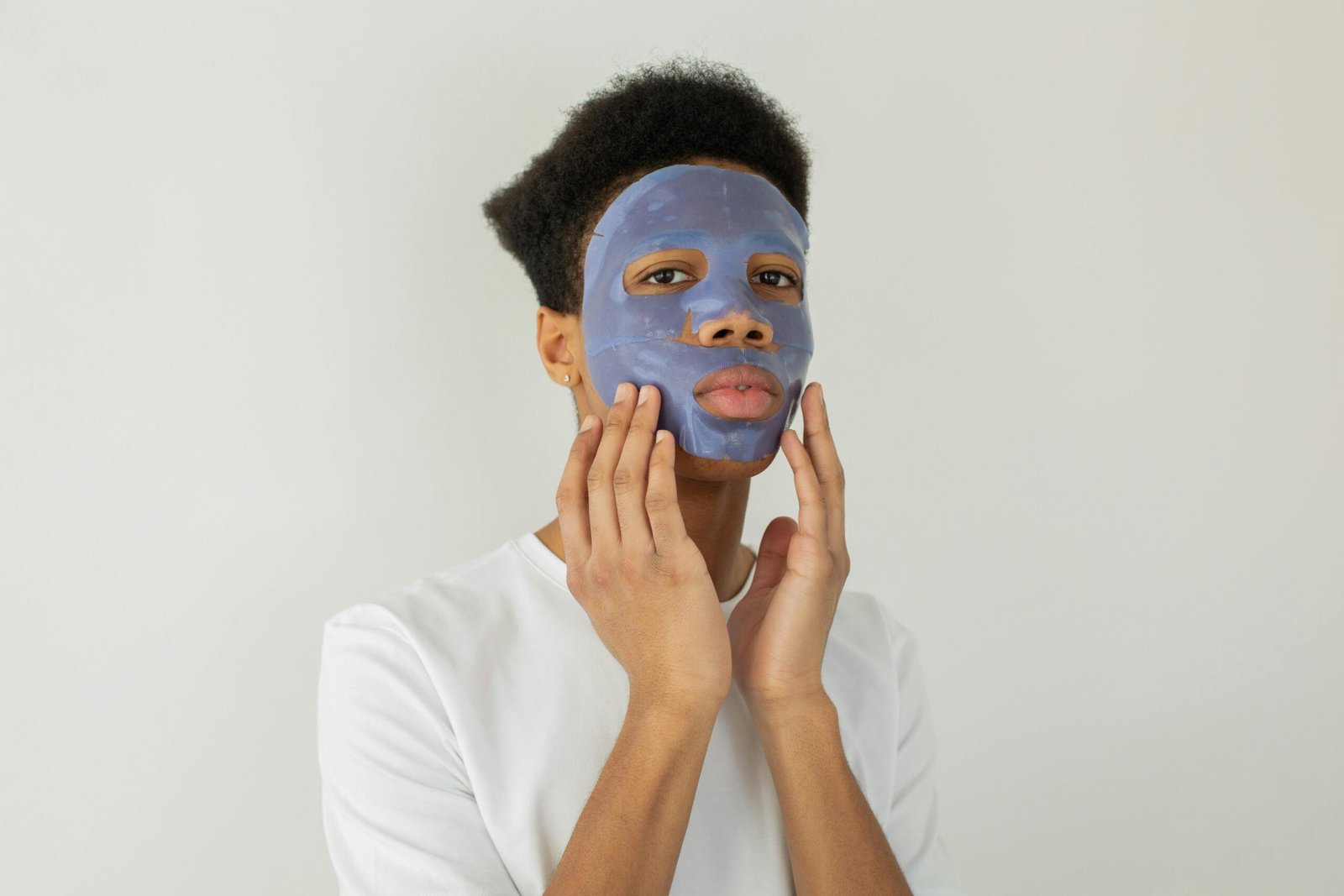 Man applying facial mask on His face