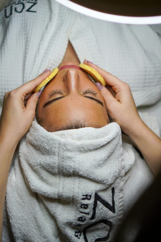 A woman lying down to receive skincare treatment