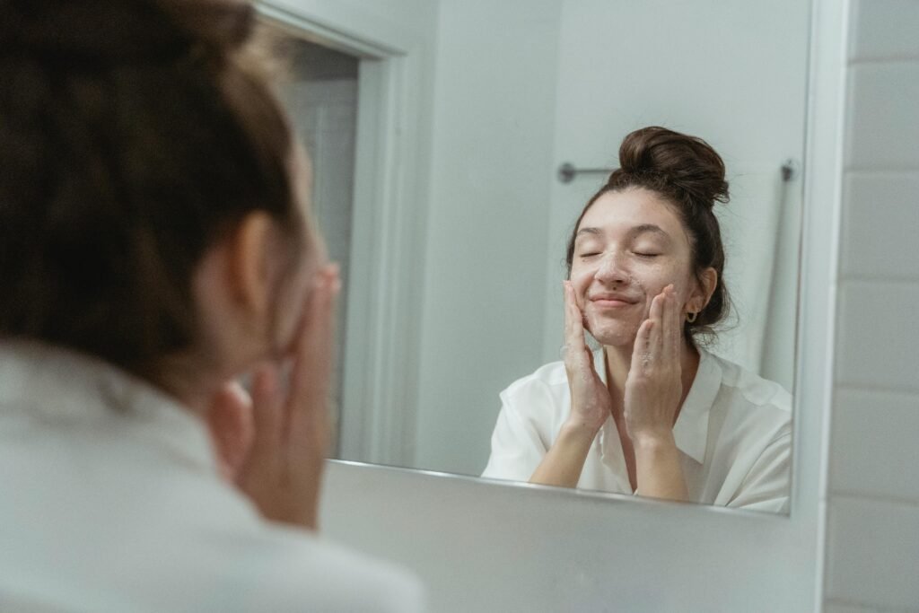 A woman washing her face and comparing gel, foam, and cream cleansers