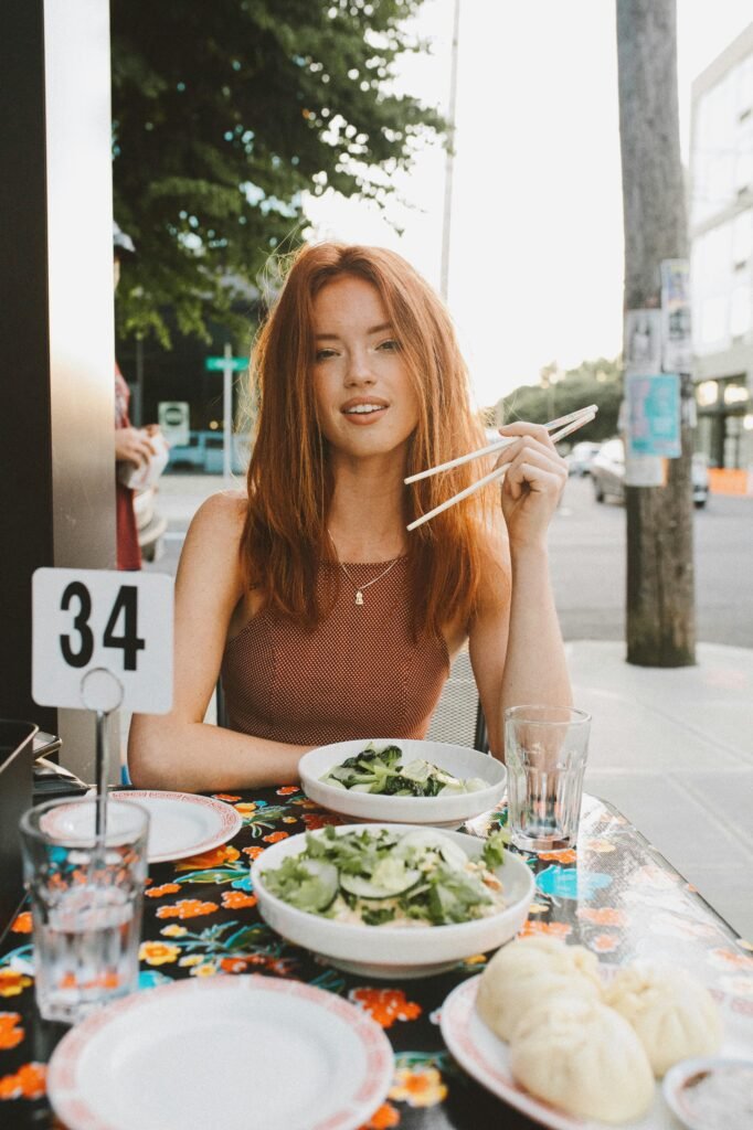 A woman sitting with food in front of her