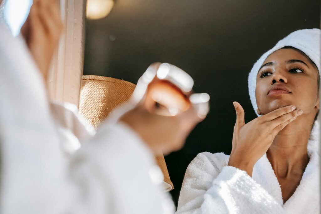 Woman applying cream on Her face