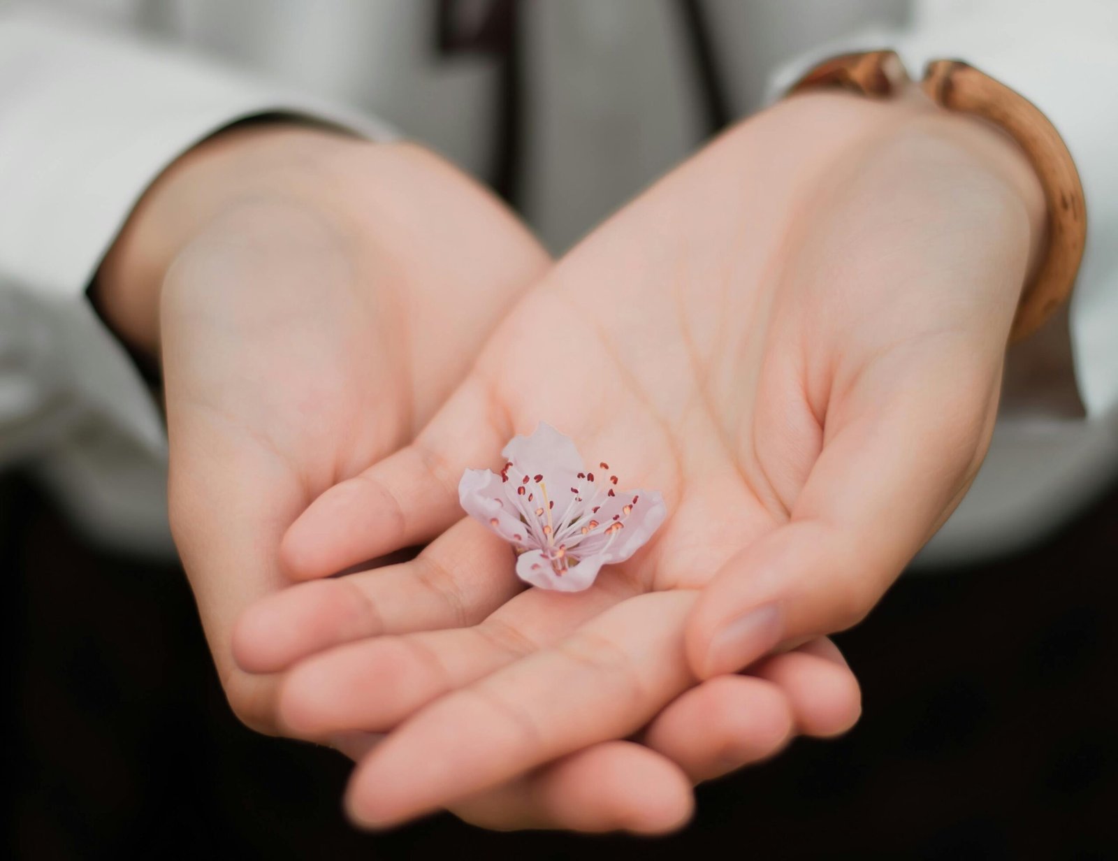 A woman holding a flower - Giving Skin